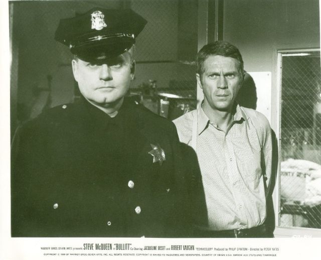 Frank Bullitt (Steve McQueen) with a policeman.